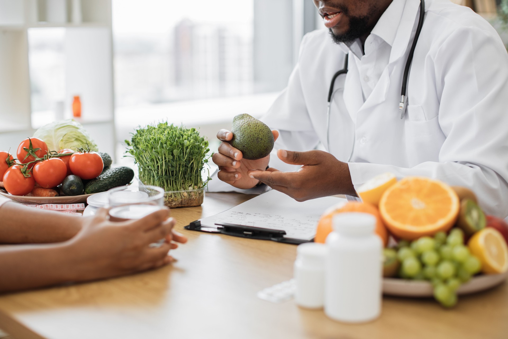 Man with green fruit chatting during appointment in clinic