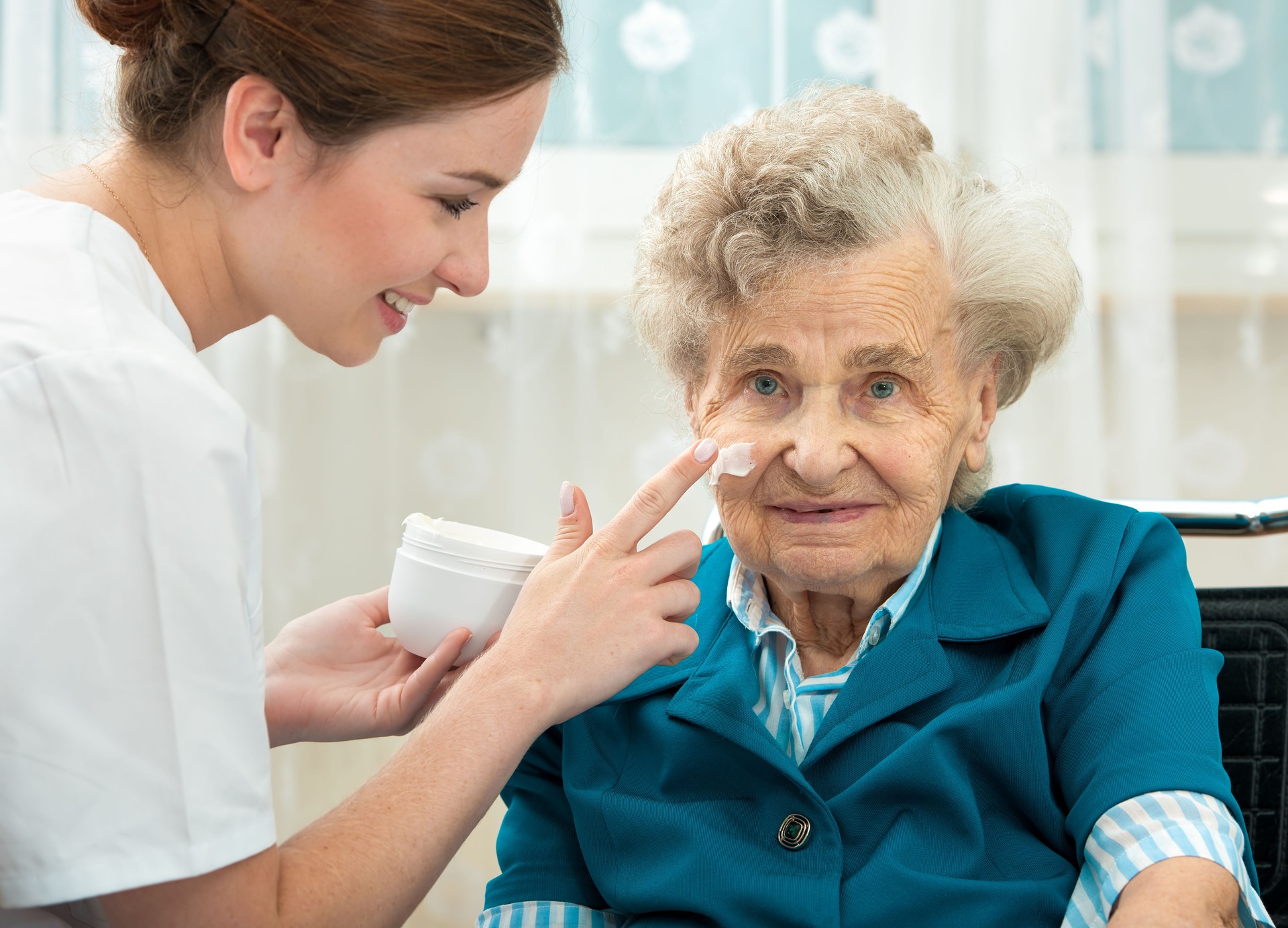 Elderly woman is assisted by nurse at home
